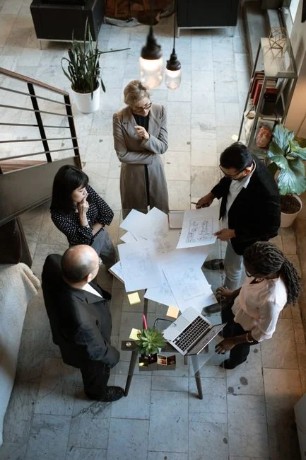 Overhead view of a diverse team working together on a project in a modern office environment.